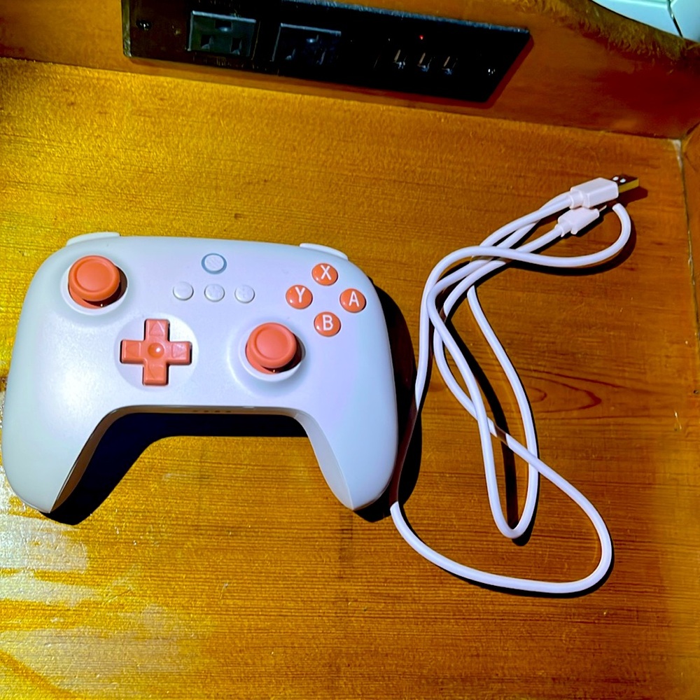 8BitDo controller, brand new never used, in perfect condition. orange color way